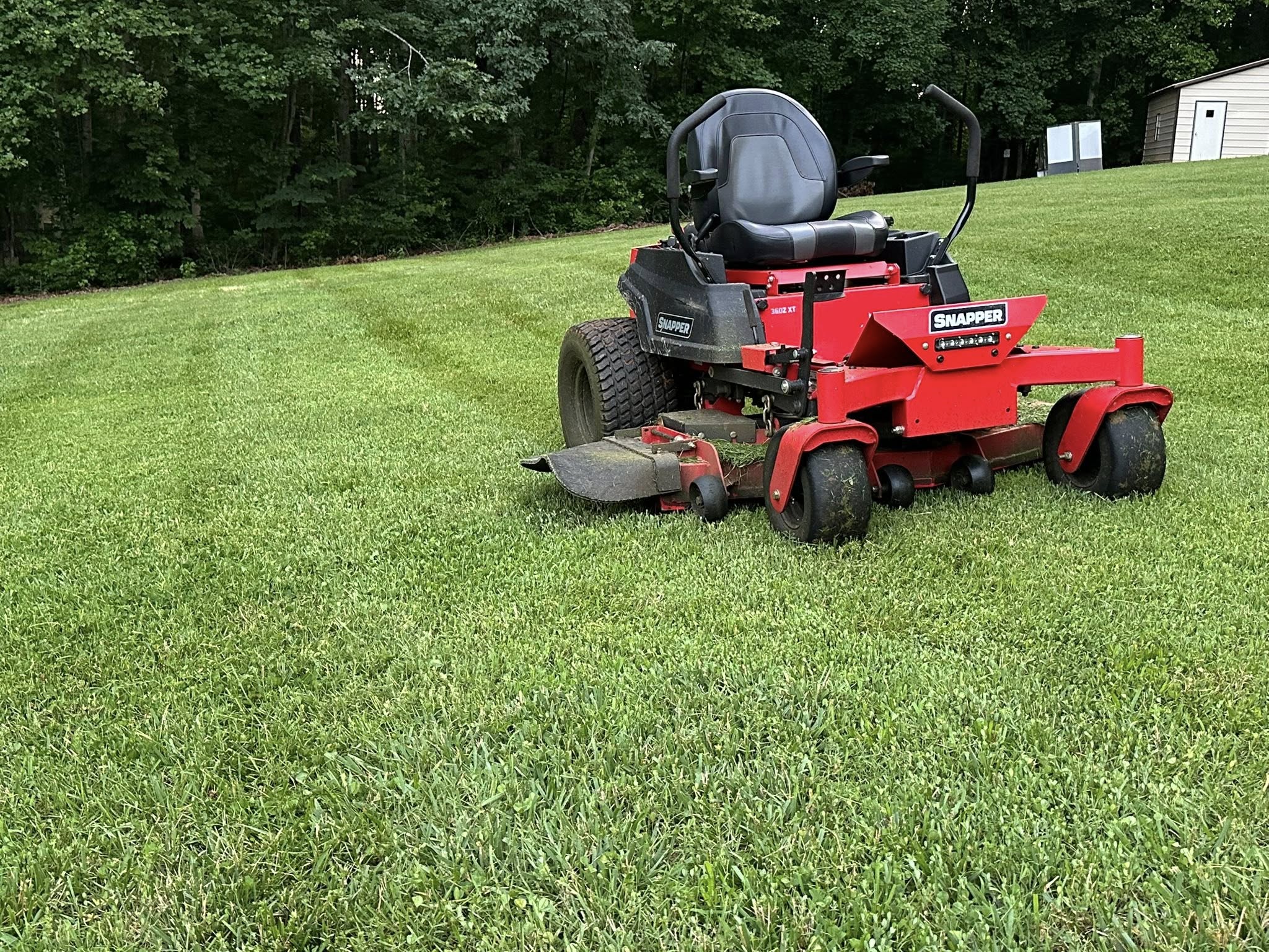 Professional lawn mowing with striped finish